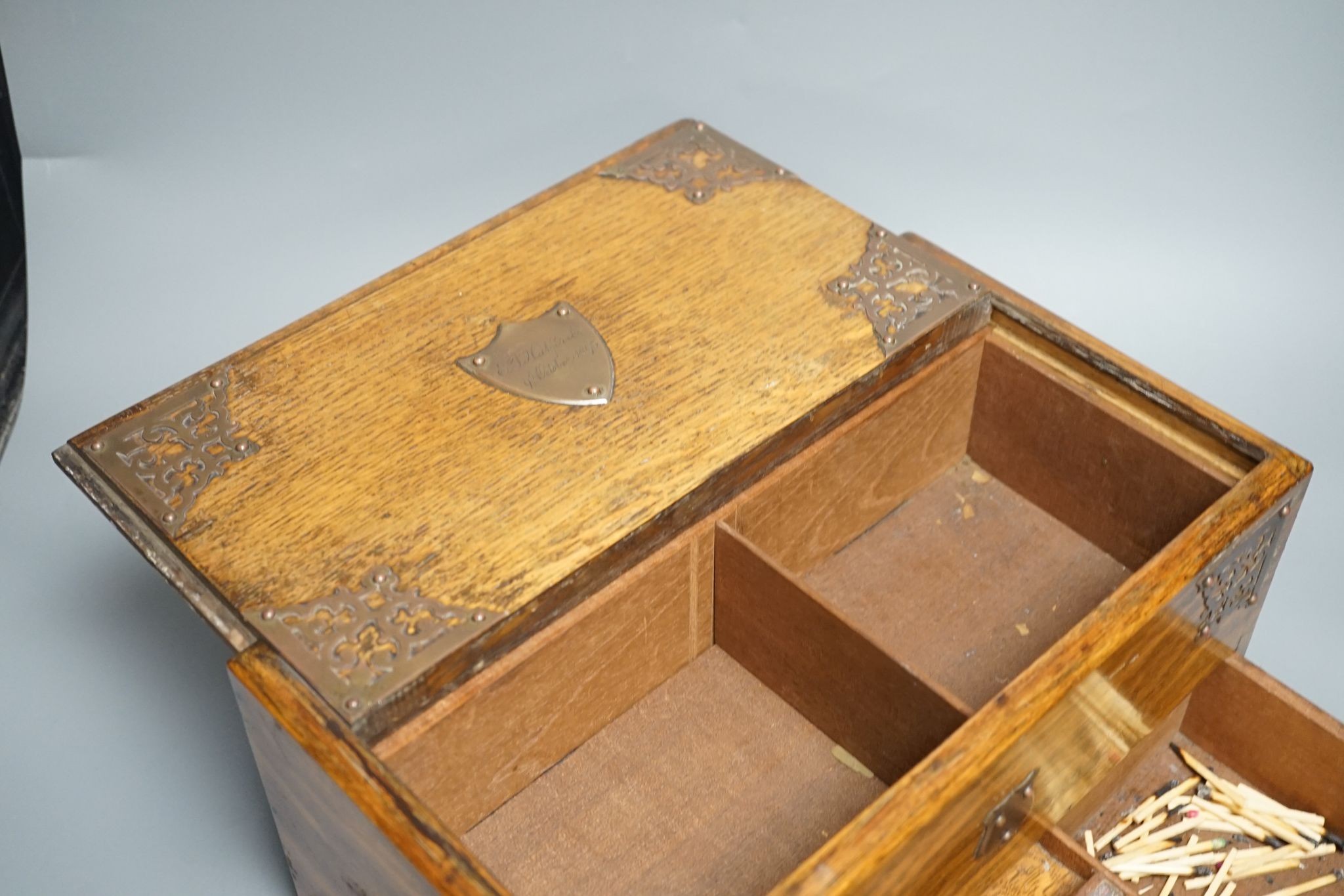 A Victorian oak smoker's box, with brass mounting, 30 cms wide x 17 cms high.